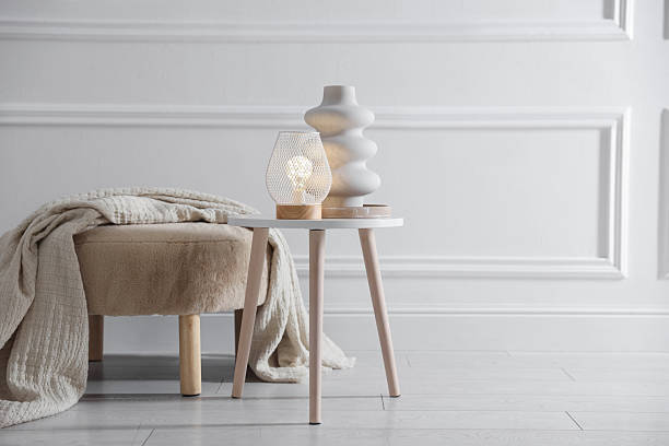 istock Stylish lamp and vase on white table near pouf indoors, space for text 2252388577