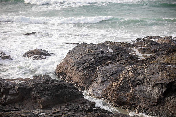 Waves crashing on the rocks at Godrevy Beach in Cornwall UK.