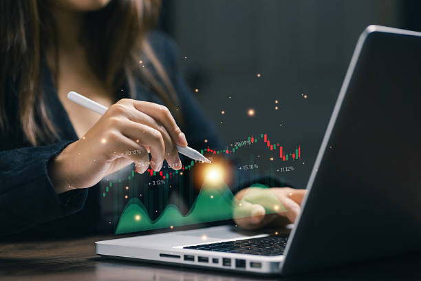 istock A professional analyzes a financial chart on a laptop with a digital dashboard overlay, representing market analysis, trading performance, investment strategy, and data-driven decisions. 2252390311