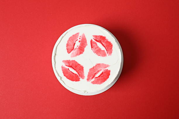 Colorful cake decorated with red lips on a colored background