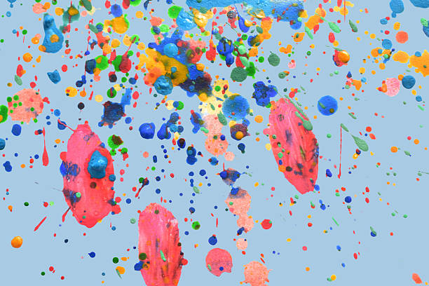 Abstract pattern of colored watercolor paint splashes on a colored background.