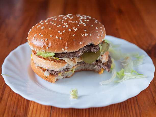 istock Delicious Half-Eaten Classic Double Cheeseburger on White Plate 2252394606