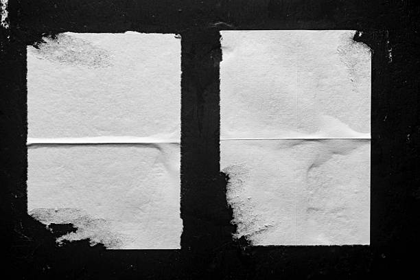 istock two white posters with folds on a black wall 2252394875