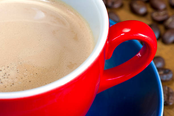 istock Red Coffee Cup with Frothy Latte Close-Up 2252398167