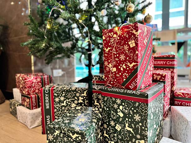 istock Colorful gift boxes are placed on the ground around the Christmas tree. 2252403050