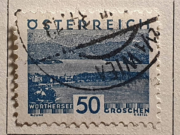 Postal stamp collection background with magnifying glass, monocle and tweezers on philatelist desk. Philately concept.