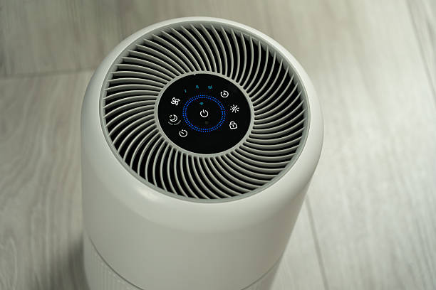 istock modern white smart air purifier with touch control panel and led display for healthy home environment and allergy relief in minimalist room. Stop smog, clean air and the environment 2252404513