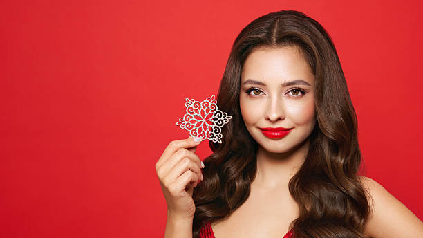 istock Beautiful young woman with glowing snowflake 2252405280
