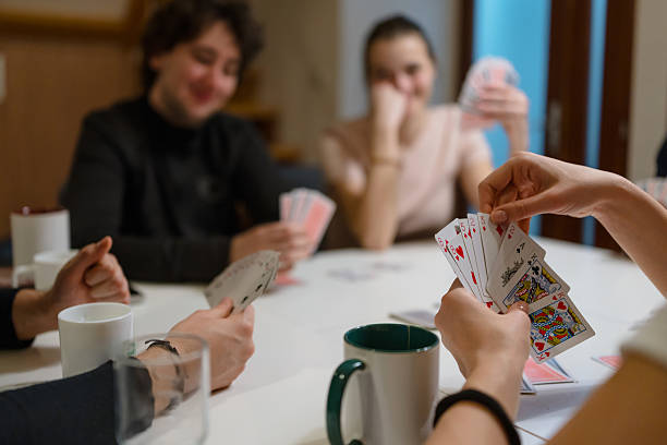 istock Playing Cards on Table with Players’ Hands 2252406629