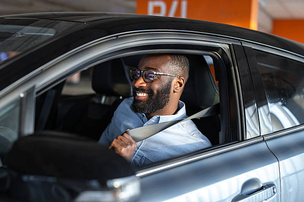 istock Man fastening seatbelt inside a modern car preparing for safe driving 2252406770