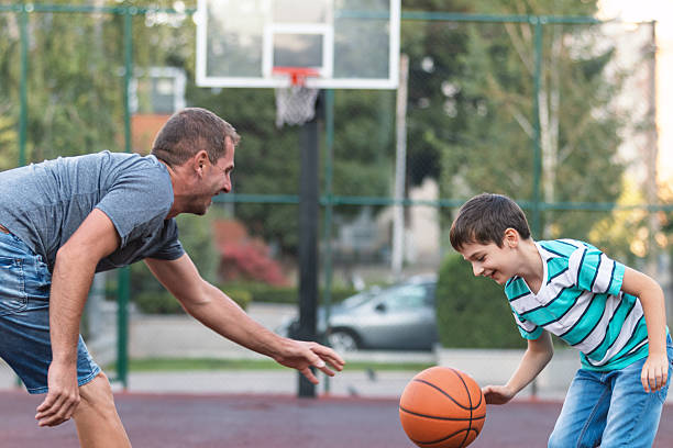 istock Father and Son Sharing a Game on the Court 2252407896