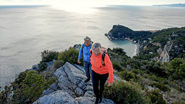 istock Mature couple hike on ridge above sea 2252409049