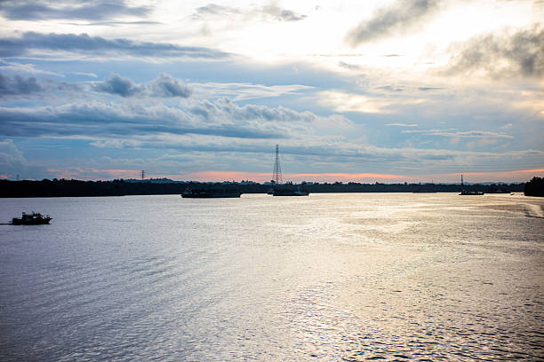 istock Panoramic View of Calm River Bay under Dramatic Overcast Sky at Golden Hour 2252410384