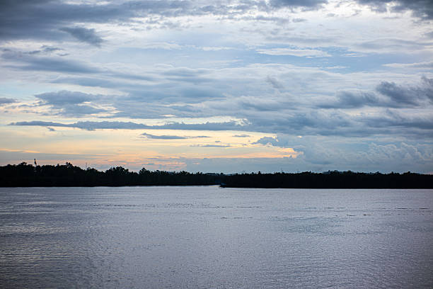 Panoramic View of Calm Bay Waters Under Scattered Clouds at Twilight