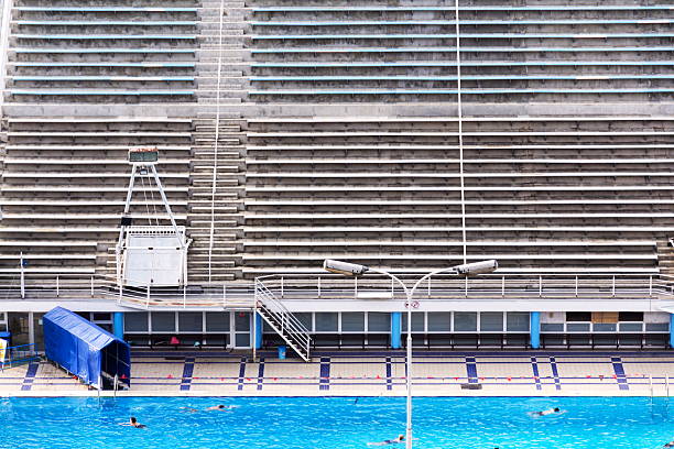 Unrecognizable people swimming in beautiful outdoors public pool, Podoli swimming complex, Prague, Czech republic