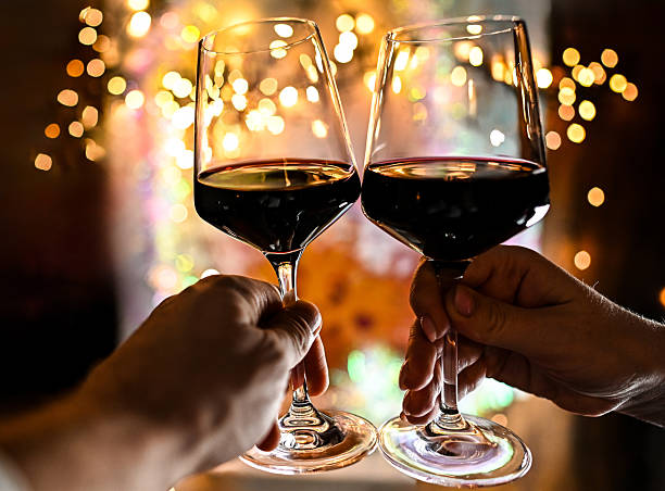 istock Couple clinking red wine glasses cheering celebration 2252413299