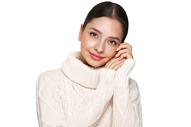 istock Young beautiful woman in a warm  white sweater 2252418368