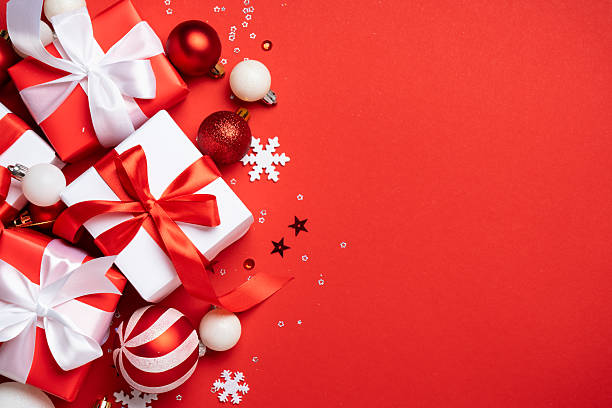 istock Red and white Christmas decorations and gifts on red background. 2252418559