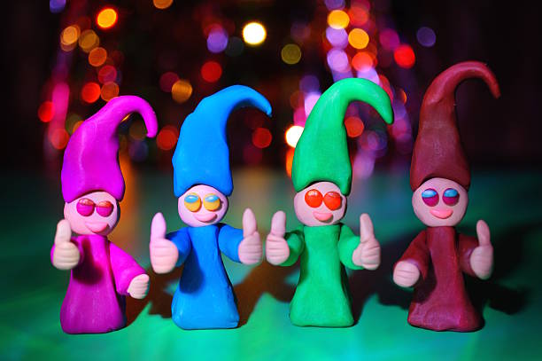 Four joyful colored dwarfs made of plasticine.