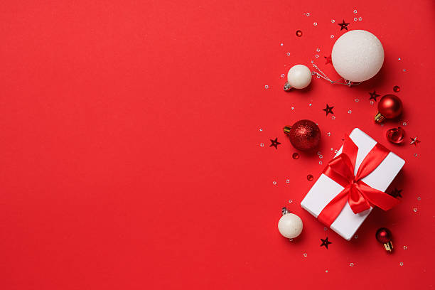 istock Red and white Christmas decorations and gifts on red background. 2252419101