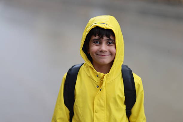 a boy going to school on a rainy day