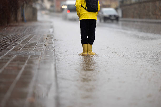 istock A boy going to school on a rainy day 2252420206
