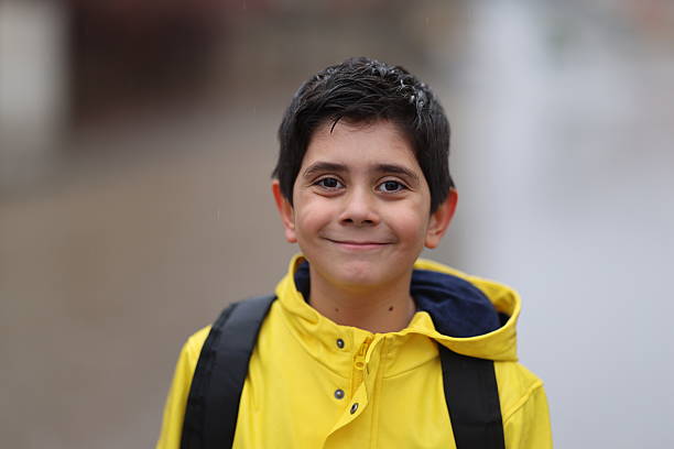 a boy going to school on a rainy day