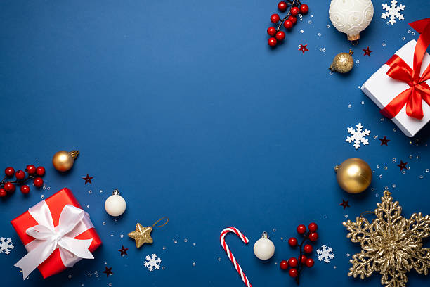 istock Red and white Christmas decorations and gifts on blue background. 2252420904