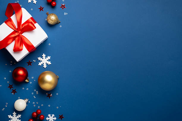 istock Red and white Christmas decorations and gifts on blue background. 2252420931