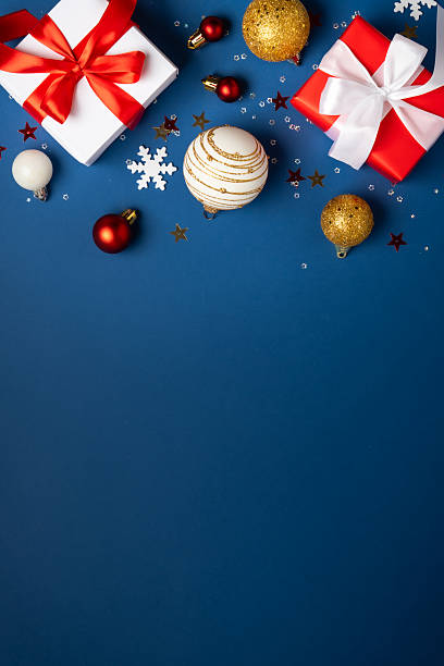 istock Red and white Christmas decorations and gifts on blue background. 2252420939