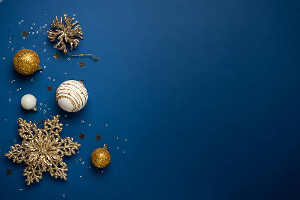 istock White and golden Christmas decorations on navy background. 2252420971