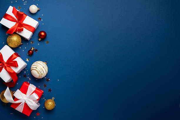 istock Red and white Christmas decorations and gifts on blue background. 2252420973