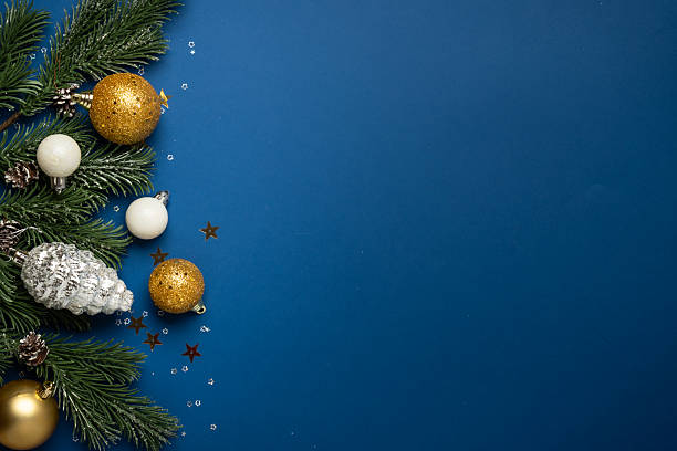 istock White and golden Christmas decorations and gift box on navy background. 2252421036