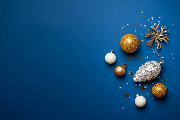 istock White and golden Christmas decorations on navy background. Flat lay image with space for text. 2252421038