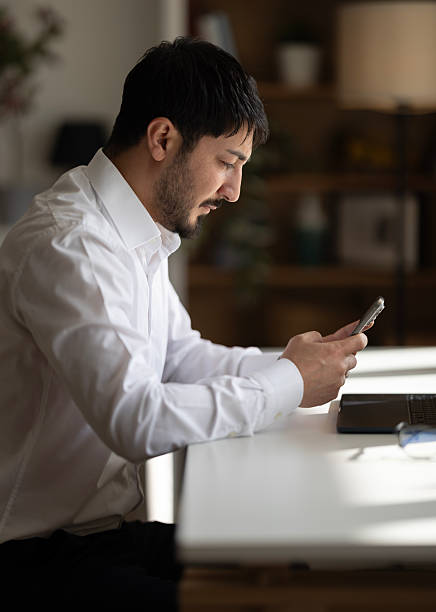 istock Handsome young man texting by phone 2252421187