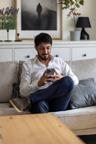 istock Handsome young man texting by phone 2252421235