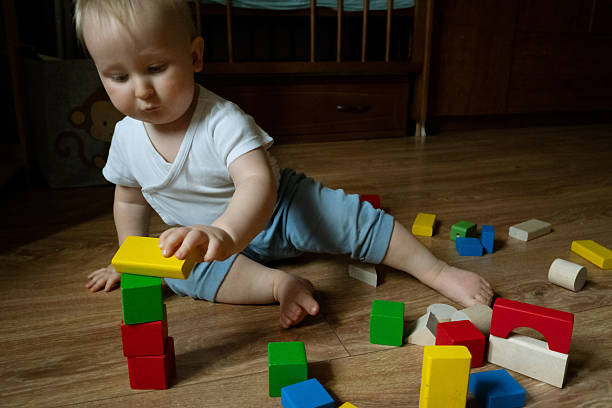 3d lettered building block toy cube spelling baby, white background