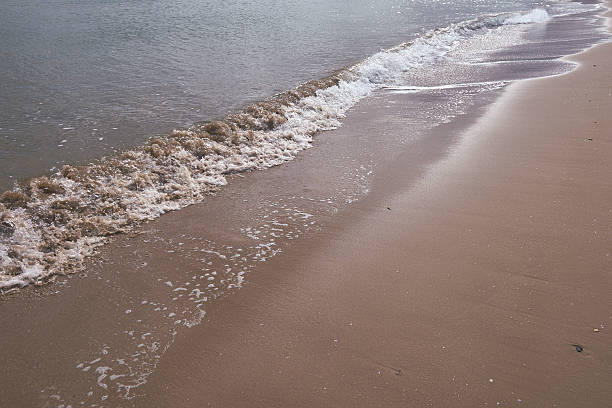 istock A secluded brown sand beach with gentle waves 2252426874