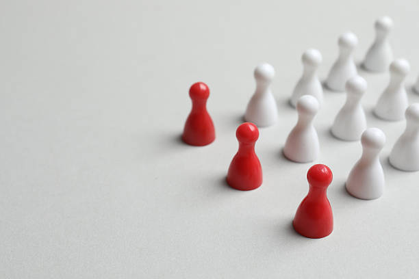 istock Group of colored pawns on a table. Concept of unity 2252431268