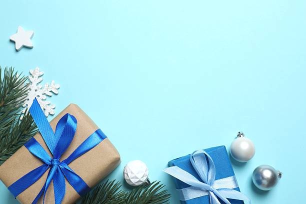 istock Christmas gift box and decorations on blue background,  seasonal greeting 2252431322