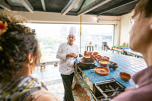 istock Chef shows tourists how to cook Mexican dish 2252431629