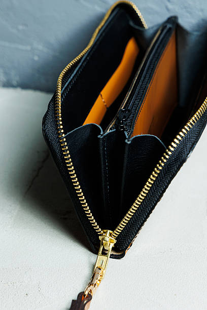 istock Handmade black leather purse on a white background. Wallet with compartments for bills 2252431645