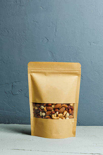 istock Roasted almonds in a cardboard kraft bag. Delicious peanuts. 2252432915