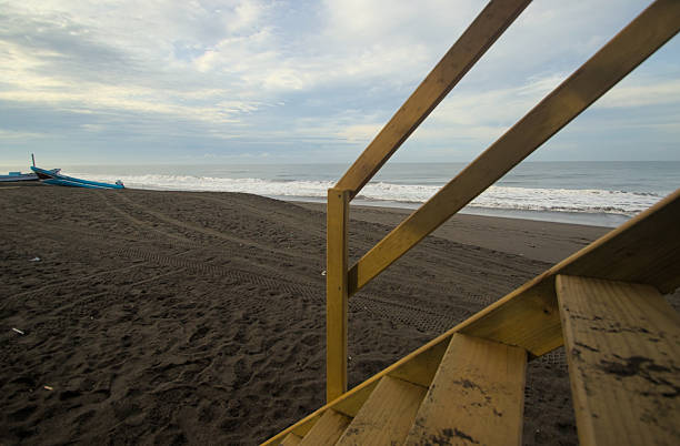 Coastal lifeguard station beside sandy shoreline