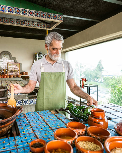 Mature man preparing chiles en nogada in Mexican cooking class