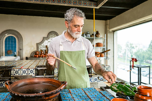 Mature man preparing chiles en nogada in Mexican cooking class