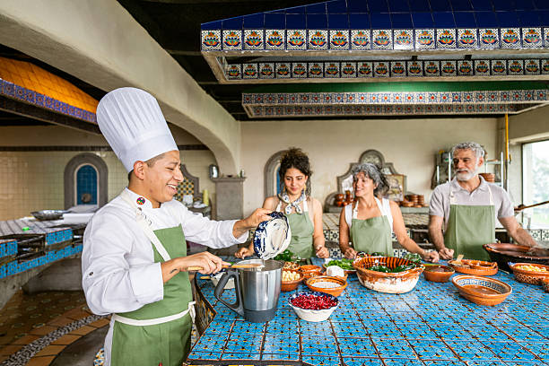 Chef shows tourists how to cook Chiles en Nogada a traditional Mexican dish