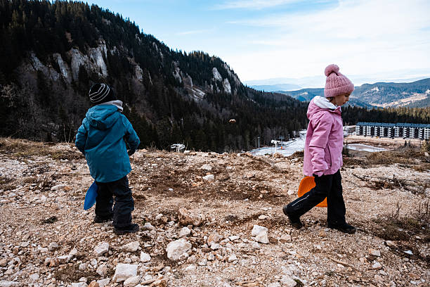Family having fun in mountains hiking together with baby travel adventure vacations outdoor healthy lifestyle couple relaxing above clouds