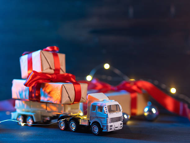istock A toy Christmas truck is transporting gift boxes. Copy space 2252439250