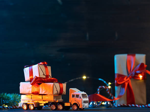 istock A toy Christmas truck is transporting gift boxes. Copy space 2252439254